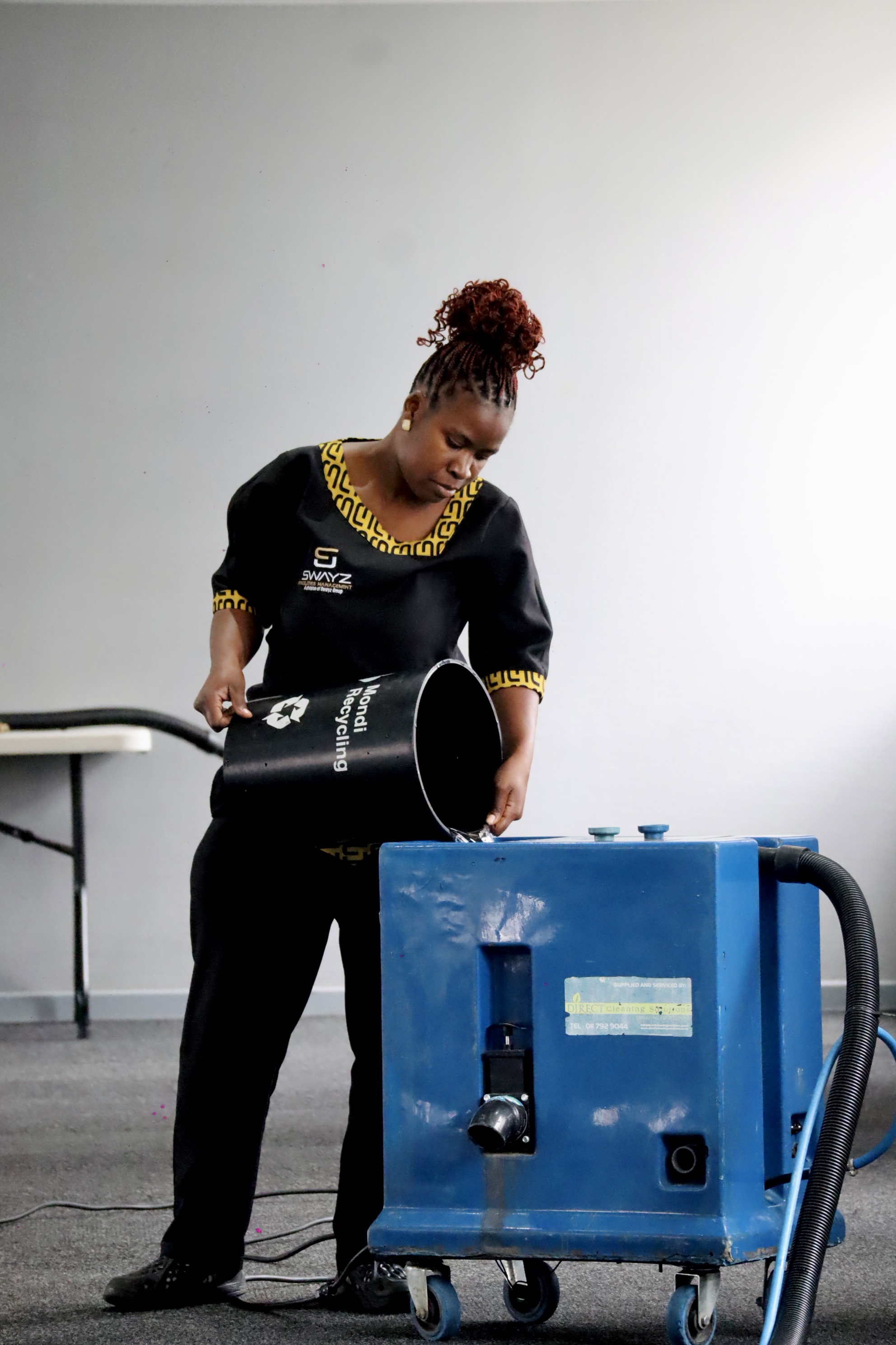 Swayz Facilities Management staff member operating cleaning equipment