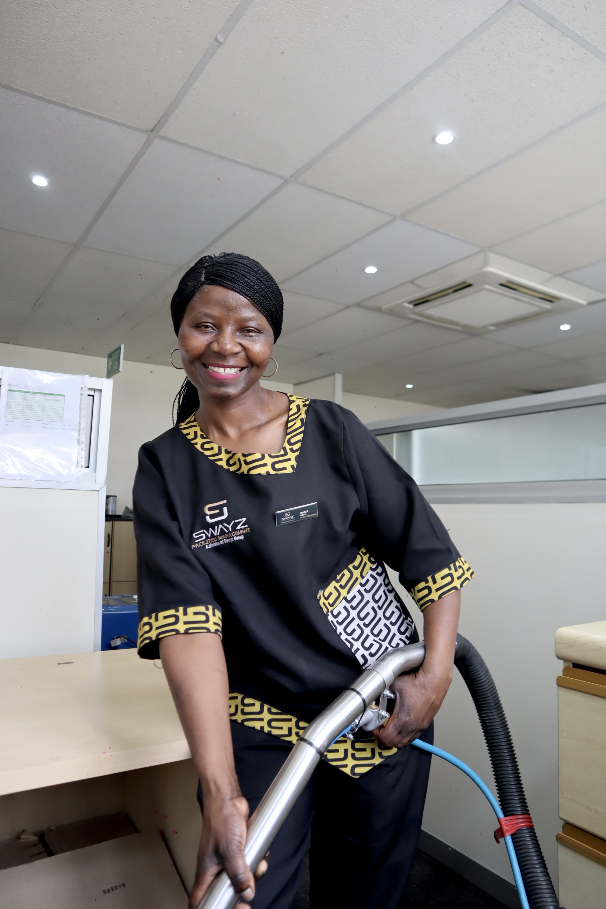 Swayz Facilities Management team member using cleaning equipment in an office