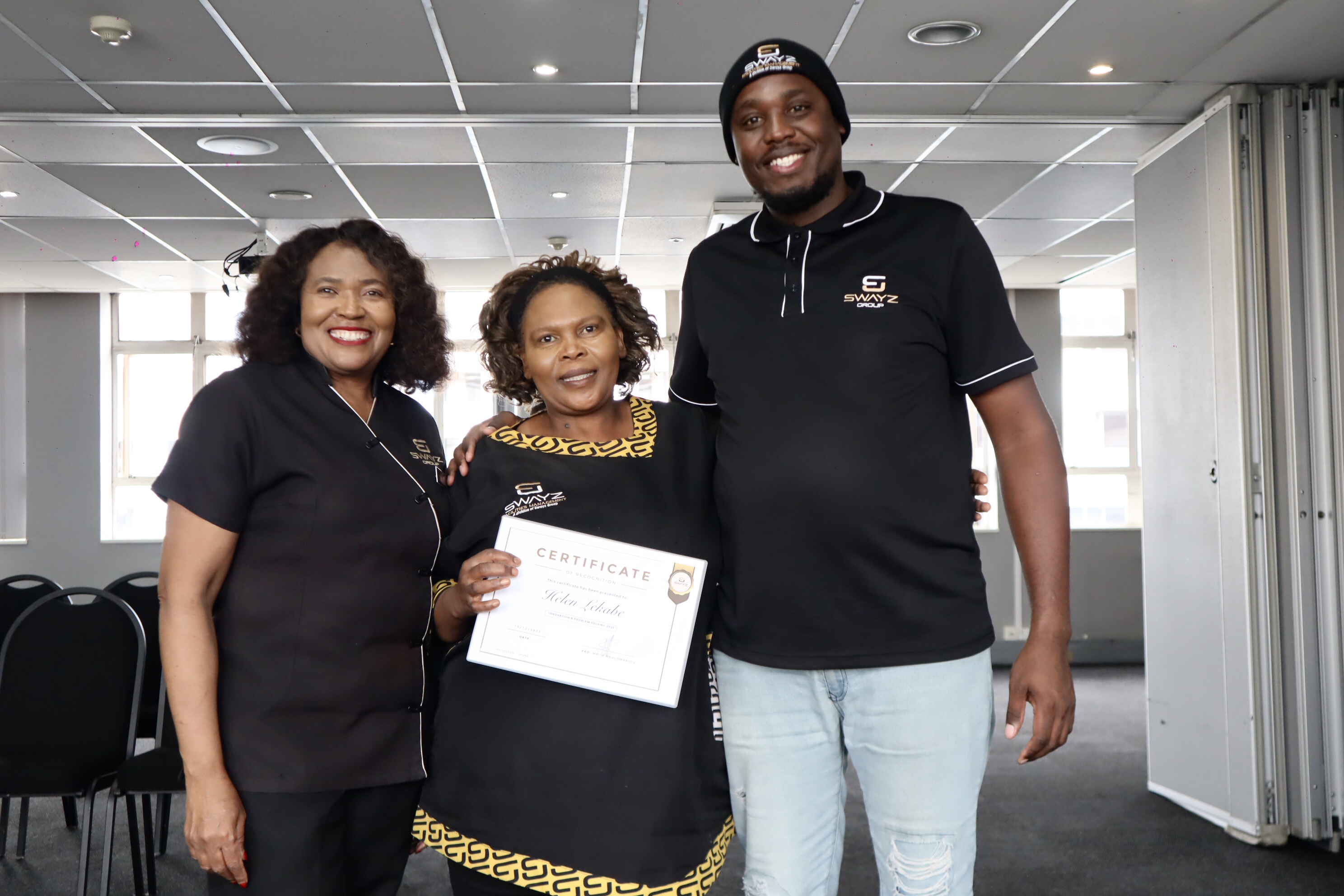 Swayz Facilities Management team posing with a certificate