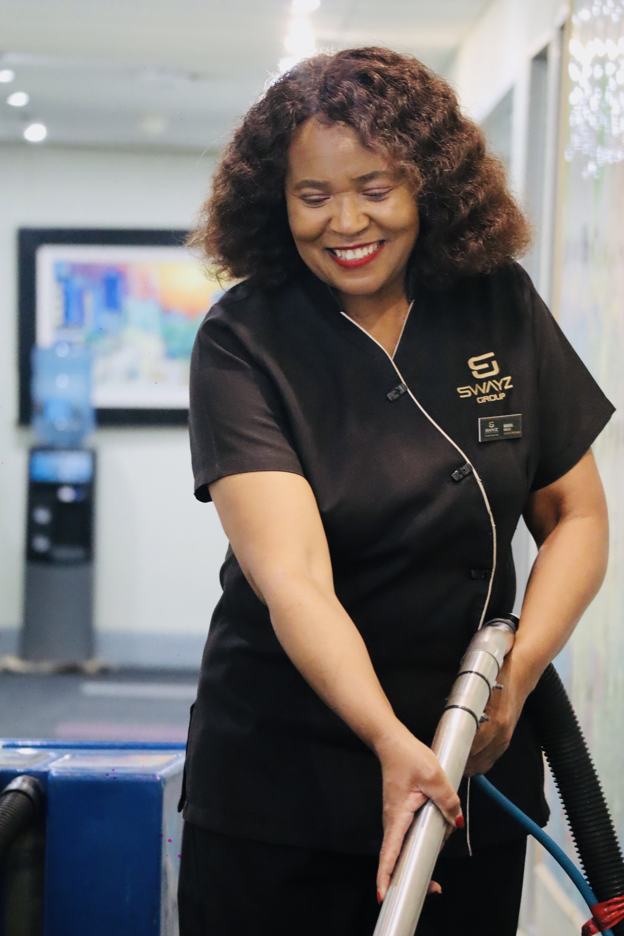 Swayz Facilities Management staff member using vacuum extraction equipment
